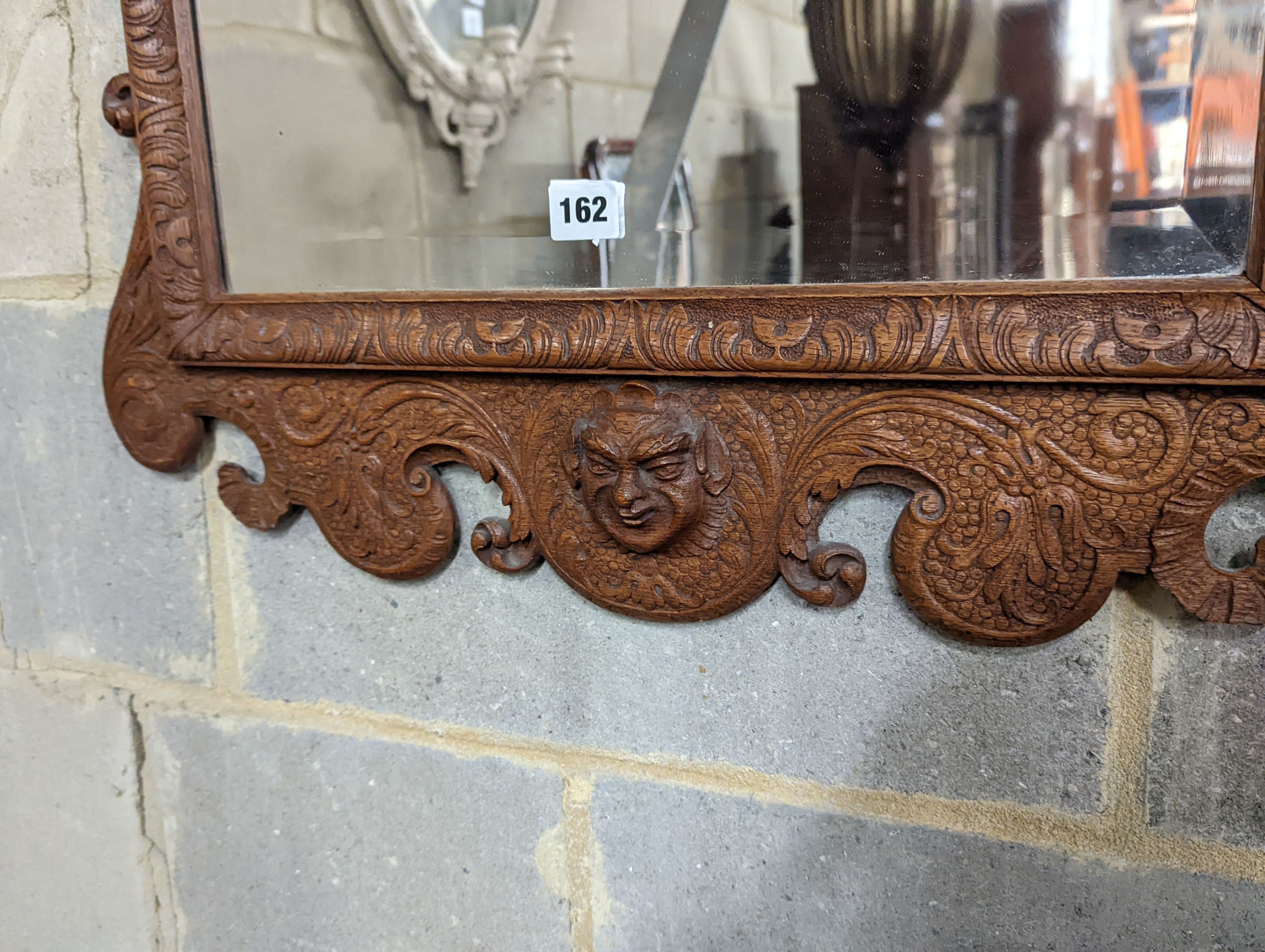 An 18th century style carved wood wall mirror, width 64cm, height 124cm